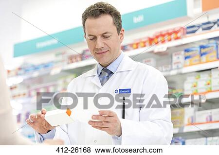 Stock Photo - Pharmacist filling prescription in pharmacy. Fotosearch