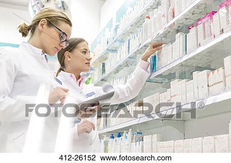 Pharmacists taking inventory in pharmacy View Large Photo Image Stock Image - Pharmacists taking inventory in pharmacy. Fotosearch