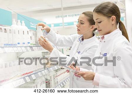 Pharmacists taking inventory in pharmacy View Large Photo Image Stock Image - Pharmacists taking inventory in pharmacy. Fotosearch