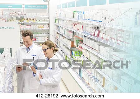 Pharmacists taking inventory in pharmacy View Large Photo Image Stock Image - Pharmacists taking inventory in pharmacy. Fotosearch