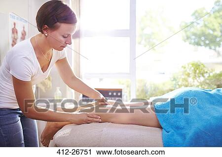 Physical therapist massaging woman’s leg View Large Photo Image Stock Image - Physical therapist massaging woman’s leg. Fotosearch