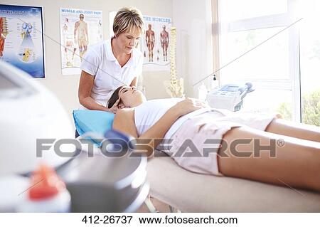 Physical therapist massaging woman’s neck View Large Photo Image Stock Photo - Physical therapist massaging woman’s neck. Fotosearch