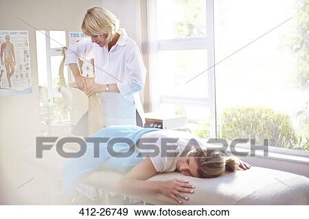 Physical therapist massaging woman’s foot View Large Photo Image Stock Photo - Physical therapist massaging woman’s foot. Fotosearch
