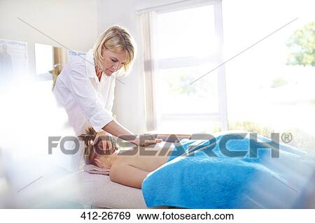 Physical therapist massaging woman’s back View Large Photo Image Stock Photo - Physical therapist massaging woman’s back. Fotosearch