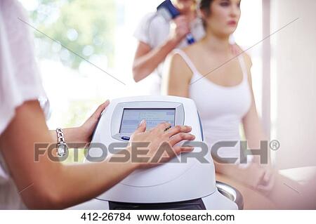 Physical therapist programming ultrasound machine View Large Photo Image Picture - Physical therapist programming ultrasound machine. Fotosearch