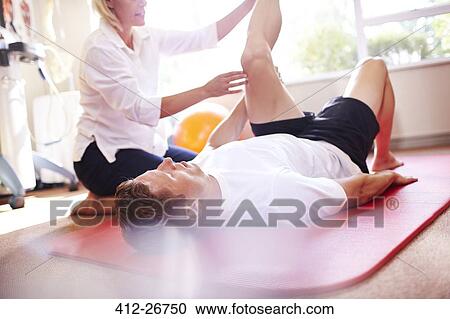 Physical therapist stretching man’s leg View Large Photo Image Stock Image - Physical therapist stretching man’s leg. Fotosearch