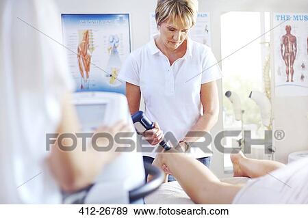 Physical therapist using ultrasound probe on woman’s leg View Large Photo Image Stock Photo - Physical therapist using ultrasound probe on woman’s leg. Fotosearch