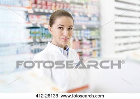 Stock Photo - Portrait of confident pharmacist in pharmacy. Fotosearch