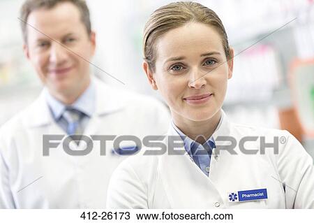 Stock Image - Portrait of confident pharmacists. Fotosearch