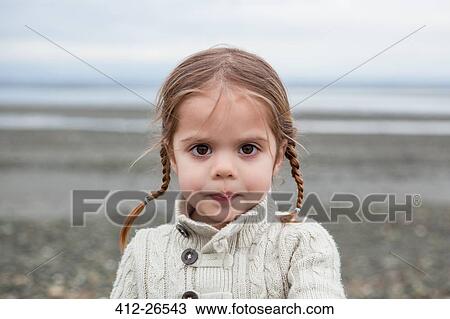 Portrait of serious girl with braided pigtails on beach View Large Photo Image Stock Image - Portrait of serious girl with braided pigtails on beach. Fotosearch