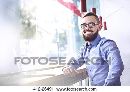Portrait of smiling businessman with beard at laptop in cafe View Large Photo Image Stock Image - Portrait of smiling businessman with beard at laptop in cafe. Fotosearch