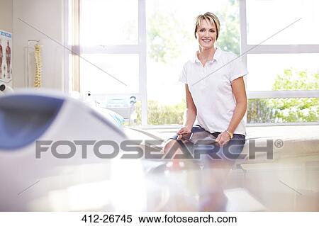 Portrait smiling physical therapist in examination room View Large Photo Image Stock Photography - Portrait smiling physical therapist in examination room. Fotosearch
