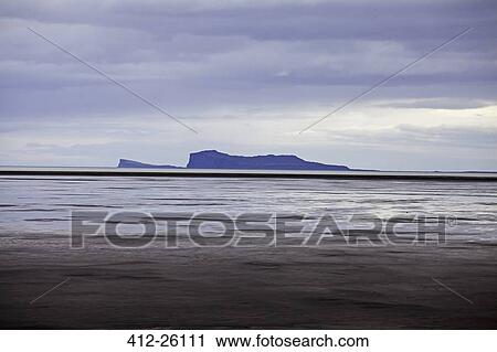 Stock Image - "Seascape and distant island, Iceland". Fotosearch