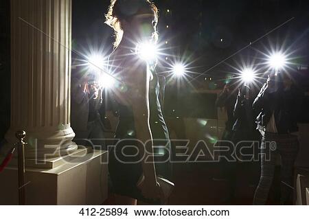 Picture - Silhouette of celebrity being photographed by paparazzi photographers at event. Fotosearch