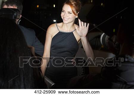 Smiling celebrity waving to paparazzi photographers at event View Large Photo Image Stock Photo - Smiling celebrity waving to paparazzi photographers at event. Fotosearch