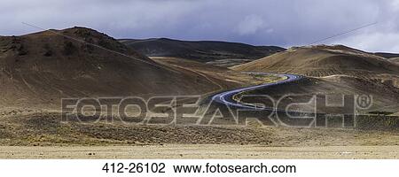 Stock Image - "Winding road through volcanic landscape, Myvatn, Iceland". Fotosearch