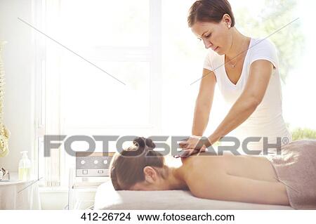 Woman receiving massage by masseuse View Large Photo Image Picture - Woman receiving massage by masseuse. Fotosearch