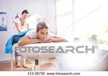 Woman receiving massage by physical therapist View Large Photo Image Stock Image - Woman receiving massage by physical therapist. Fotosearch