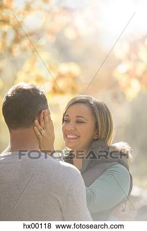 Stock Photo - Affectionate couple hugging face to face. Fotosearch