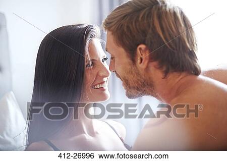 Affectionate couple smiling face to face View Large Photo Image Stock Photograph - Affectionate couple smiling face to face. Fotosearch