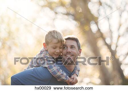 Stock Photo - Affectionate father and son piggybacking. Fotosearch