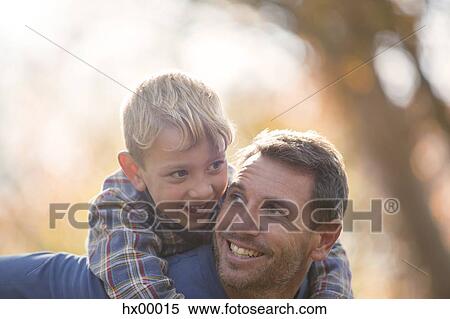 Affectionate father and son piggybacking View Large Photo Image Stock Photography - Affectionate father and son piggybacking. Fotosearch