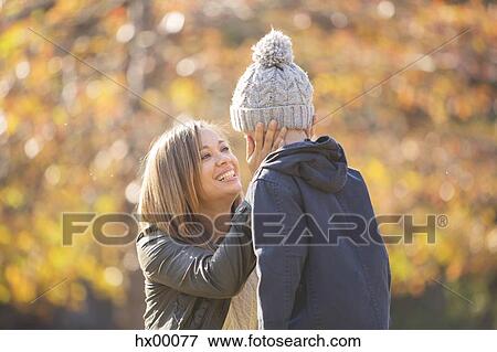 Affectionate mother touching son’s face outdoors View Large Photo Image Stock Photo - Affectionate mother touching son’s face outdoors. Fotosearch