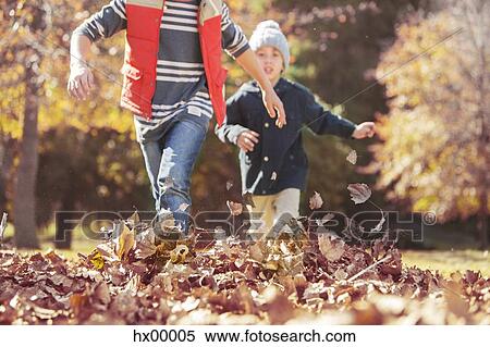 Boys running in autumn leaves View Large Photo Image Stock Photography - Boys running in autumn leaves. Fotosearch