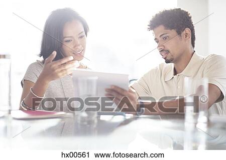 Business people using digital tablet in office View Large Photo Image Stock Image - Business people using digital tablet in office. Fotosearch