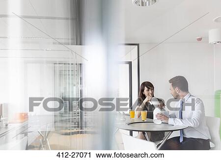 Businessman and businesswoman eating Chinese takeout food in office cafeteria View Large Photo Image Stock Image - Businessman and businesswoman eating Chinese takeout food in office cafeteria. Fotosearch
