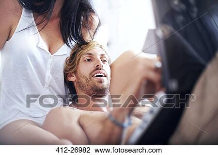 Casual couple using laptop View Large Photo Image Stock Image - Casual couple using laptop. Fotosearch
