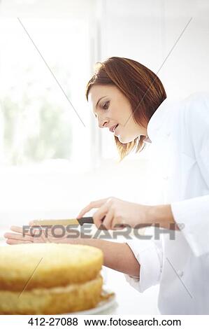 Chef frosting cake View Large Photo Image Stock Photo - Chef frosting cake. Fotosearch