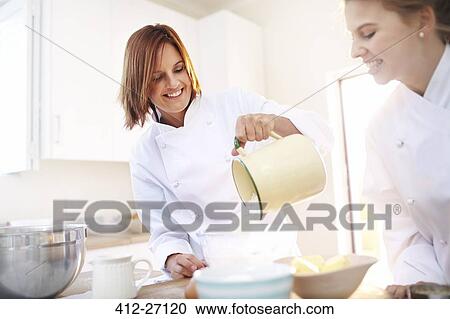 Stock Image - Chefs baking in kitchen. Fotosearch