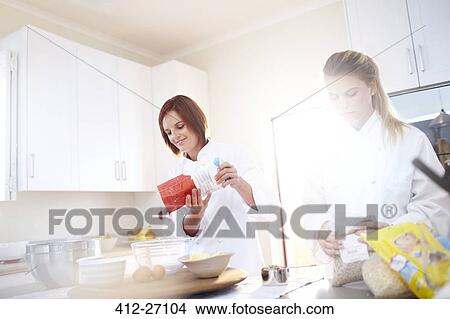 Picture - Chefs baking in sunny kitchen. Fotosearch