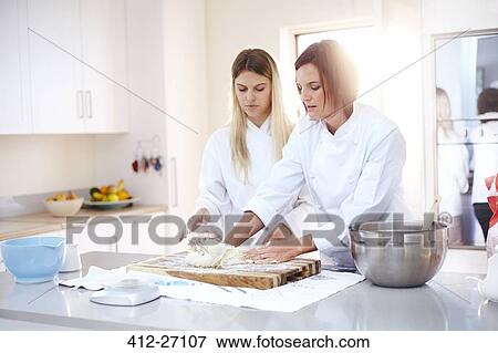 Chefs baking kneading dough in kitchen View Large Photo Image Stock Photo - Chefs baking kneading dough in kitchen. Fotosearch