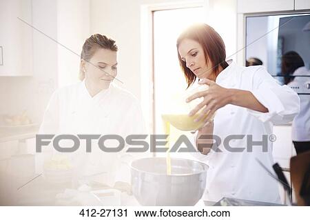 Chefs baking pouring batter in bowl View Large Photo Image Stock Image - Chefs baking pouring batter in bowl. Fotosearch