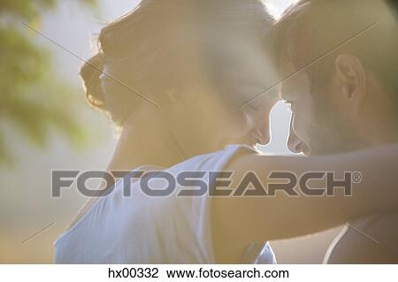 Close up affectionate couple hugging View Large Photo Image Stock Image - Close up affectionate couple hugging. Fotosearch