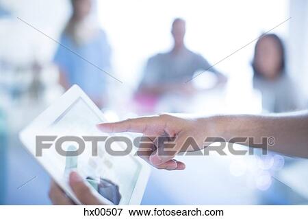 Close up businessman pointing to digital tablet in meeting View Large Photo Image Stock Photo - Close up businessman pointing to digital tablet in meeting. Fotosearch