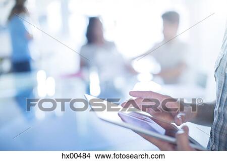 Picture - Close up businessman using digital tablet. Fotosearch