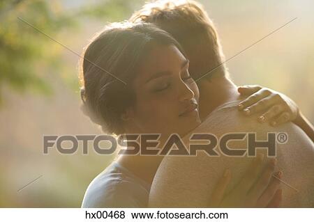 Stock Photo - Close up serene couple hugging. Fotosearch