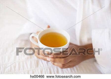 Close up woman holding cup of tea View Large Photo Image Stock Photograph - Close up woman holding cup of tea. Fotosearch