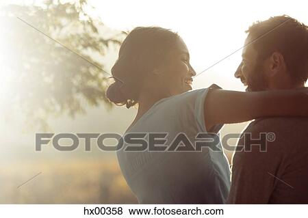 Couple hugging outdoors View Large Photo Image Stock Photo - Couple hugging outdoors. Fotosearch