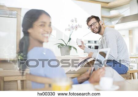 Couple relaxing with digital tablet, newspaper and coffee View Large Photo Image Stock Image - Couple relaxing with digital tablet, newspaper and coffee. Fotosearch