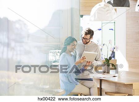 Couple using digital tablet in kitchen View Large Photo Image Stock Image - Couple using digital tablet in kitchen. Fotosearch