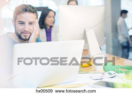 Creative business people working at laptop and computer in office View Large Photo Image Stock Photo - Creative business people working at laptop and computer in office. Fotosearch