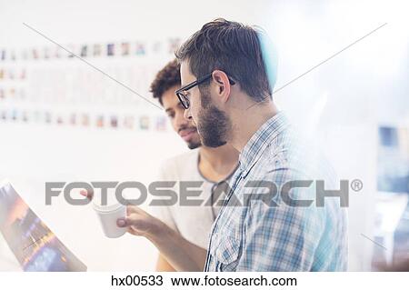 Creative graphic designers with coffee discussing proofs View Large Photo Image Stock Image - Creative graphic designers with coffee discussing proofs. Fotosearch