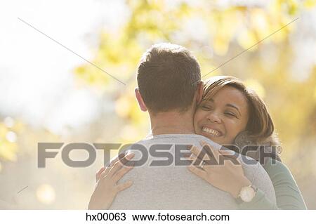 Enthusiastic couple hugging outdoors View Large Photo Image Stock Image - Enthusiastic couple hugging outdoors. Fotosearch