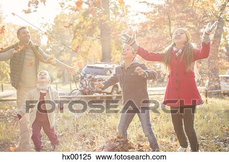 Family playing in autumn park View Large Photo Image Stock Photography - Family playing in autumn park. Fotosearch