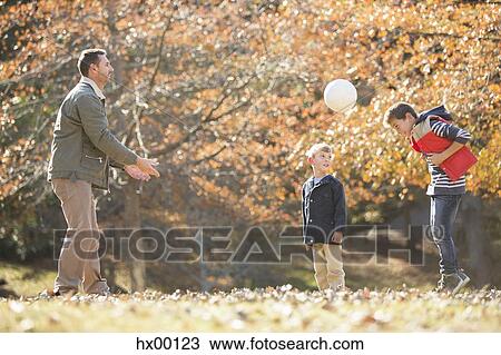 Father and sons playing soccer in autumn park View Large Photo Image Stock Image - Father and sons playing soccer in autumn park. Fotosearch