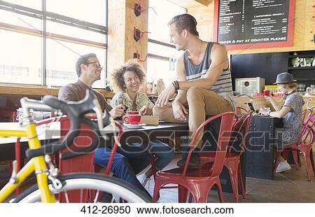 Friends hanging out talking in cafe View Large Photo Image Stock Image - Friends hanging out talking in cafe. Fotosearch